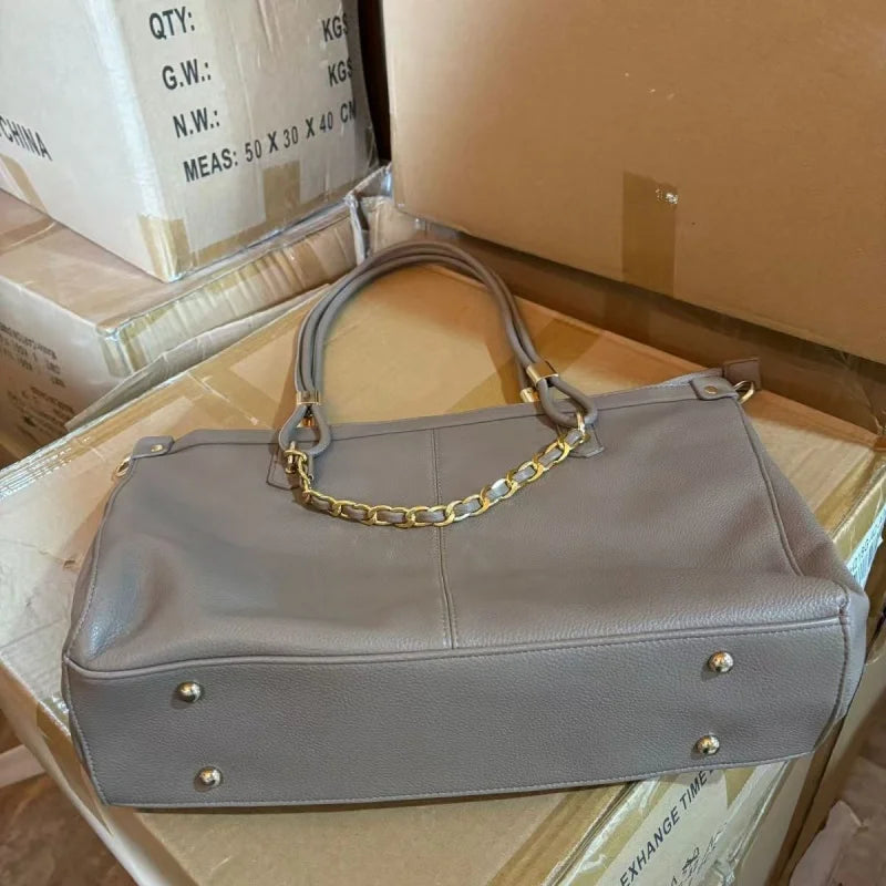 Large leather tote bag with double round handles, gold metal hardware, vertical stitching, and spacious capacity.-8