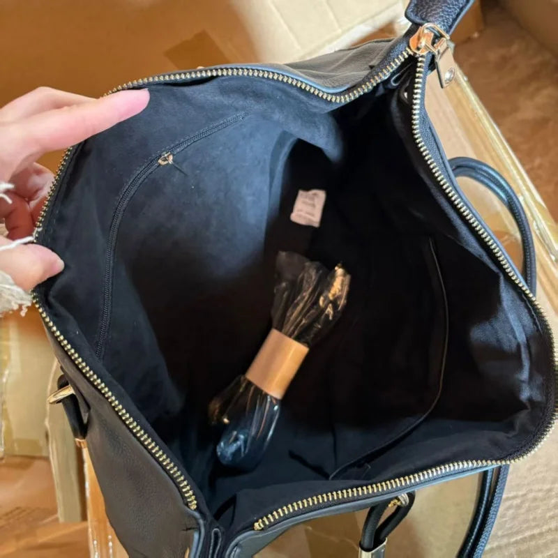 Large leather tote bag with double round handles, gold metal hardware, vertical stitching, and spacious capacity.-6
