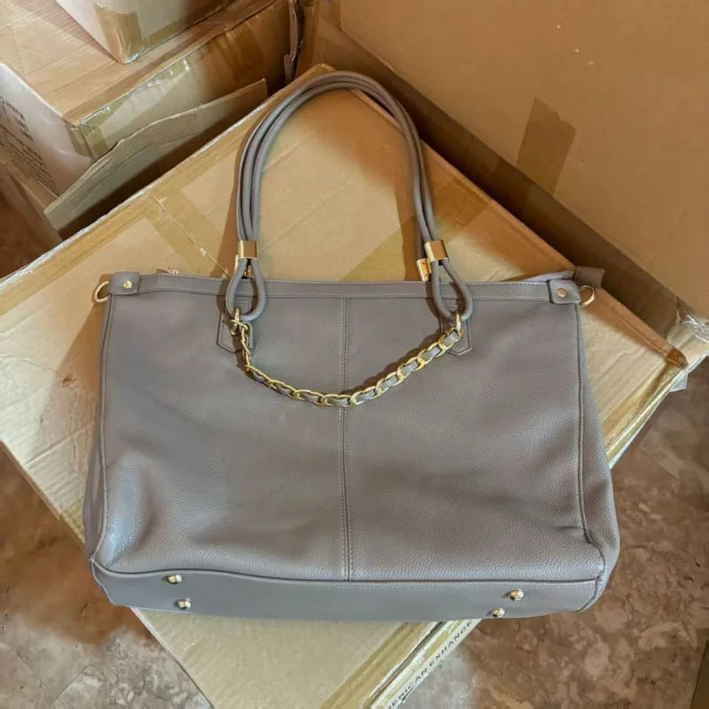 Large leather tote bag with double round handles, gold metal hardware, vertical stitching, and spacious capacity.-7