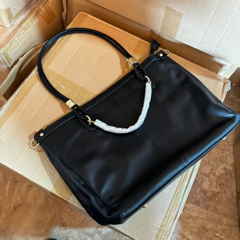 Large leather tote bag with double round handles, gold metal hardware, vertical stitching, and spacious capacity.-3