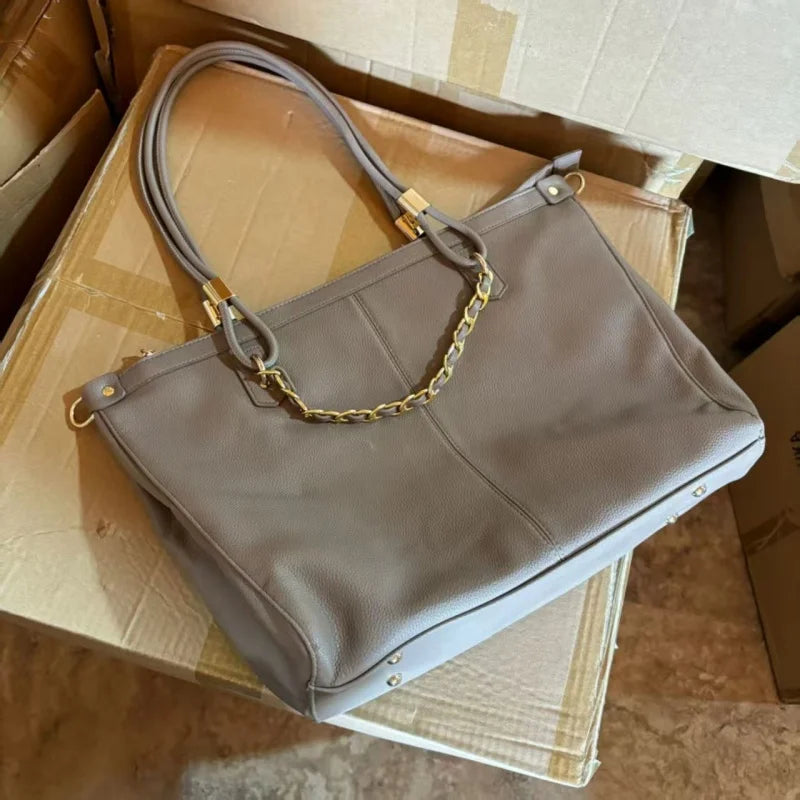 Large leather tote bag with double round handles, gold metal hardware, vertical stitching, and spacious capacity.-5